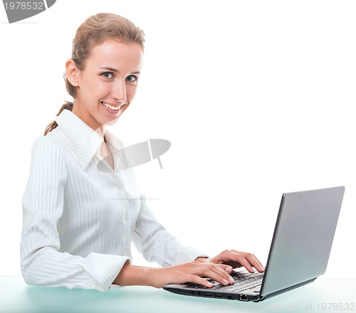 Image of friendly administrative assistant at the desk with a laptop