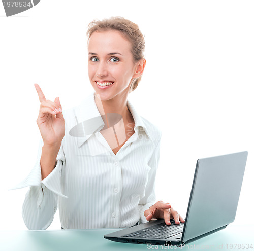 Image of friendly administrative assistant at the desk with a laptop
