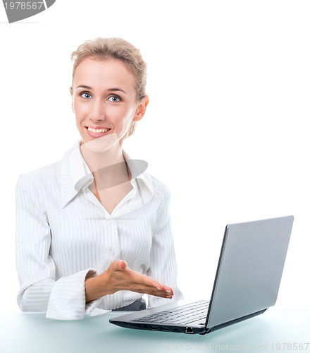 Image of friendly administrative assistant at the desk with a laptop