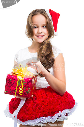 Image of girl with red Christmas cap and present on isolated white