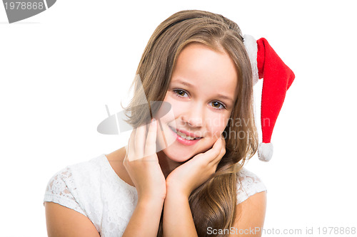 Image of beautiful girl with red Christmas cap on isolated white