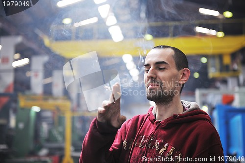 Image of industry worker smoke cigarette