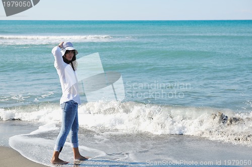 Image of happy young woman on beach