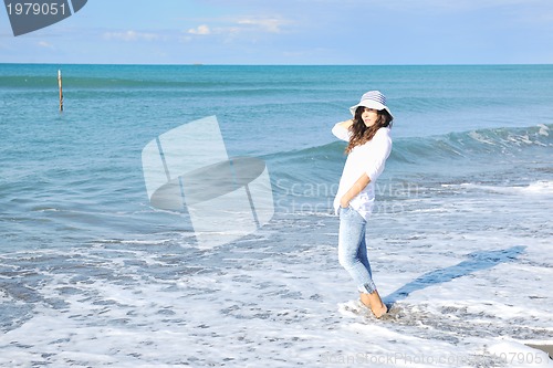 Image of happy young woman on beach