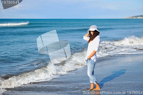 Image of happy young woman on beach