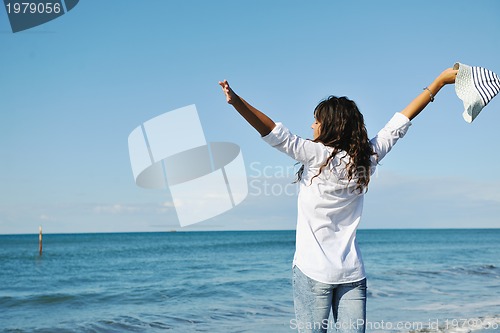 Image of happy young woman on beach