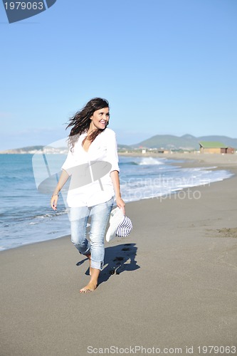 Image of happy young woman on beach