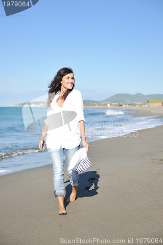 Image of happy young woman on beach