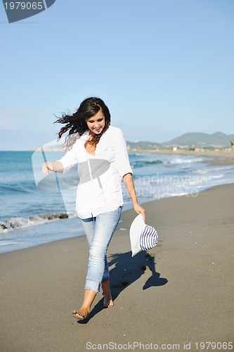 Image of happy young woman on beach