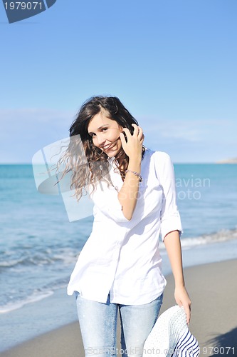Image of happy young woman on beach