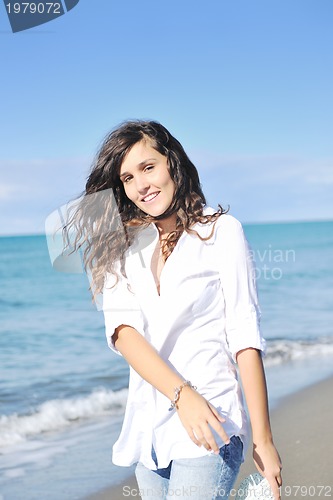 Image of happy young woman on beach