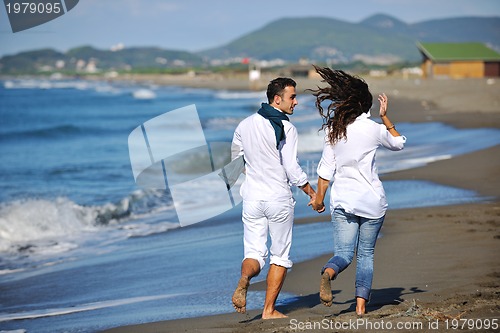 Image of happy young couple have fun at beautiful beach
