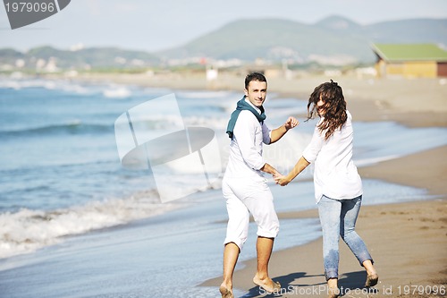 Image of happy young couple have fun at beautiful beach