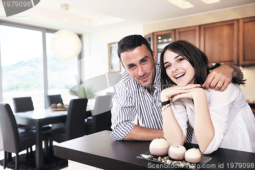 Image of happy young couple have fun in modern kitchen
