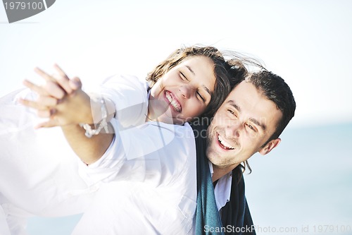 Image of happy young couple have fun at beautiful beach
