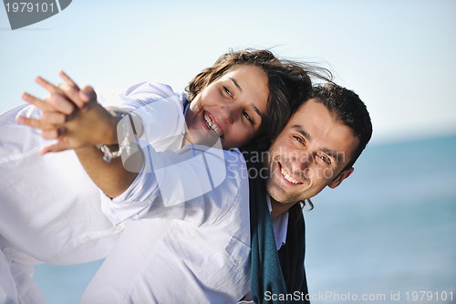 Image of happy young couple have fun at beautiful beach