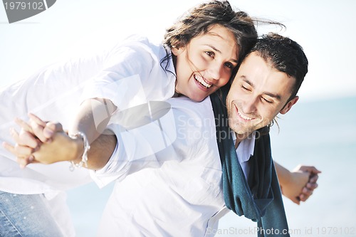 Image of happy young couple have fun at beautiful beach