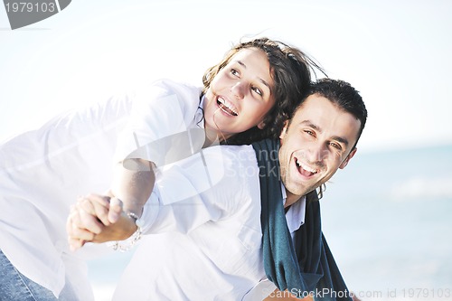 Image of happy young couple have fun at beautiful beach