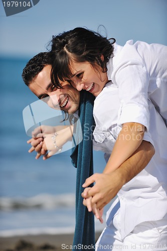 Image of happy young couple have fun at beautiful beach
