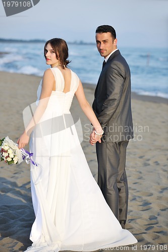 Image of romantic beach wedding at sunset
