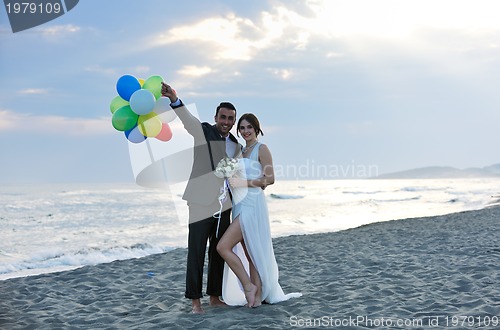 Image of romantic beach wedding at sunset