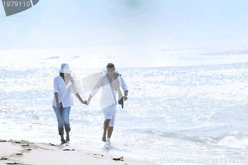 Image of happy young couple have fun at beautiful beach