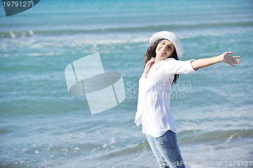Image of happy young woman on beach