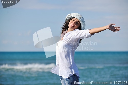 Image of happy young woman on beach