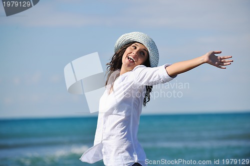 Image of happy young woman on beach