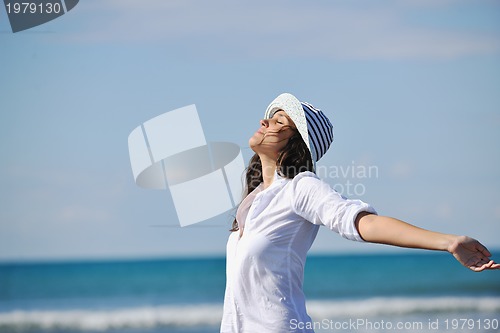 Image of happy young woman on beach
