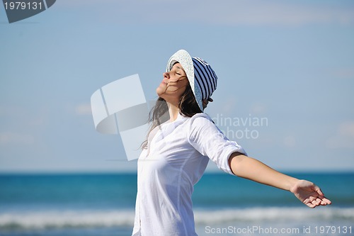 Image of happy young woman on beach