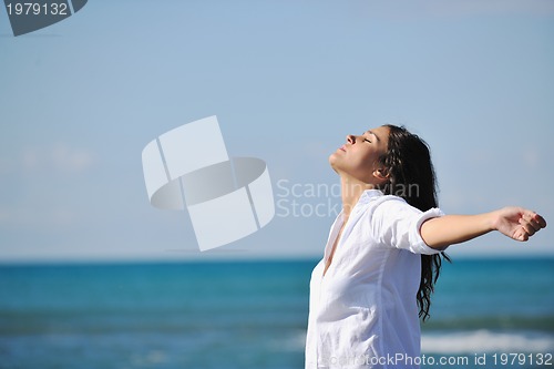 Image of happy young woman on beach