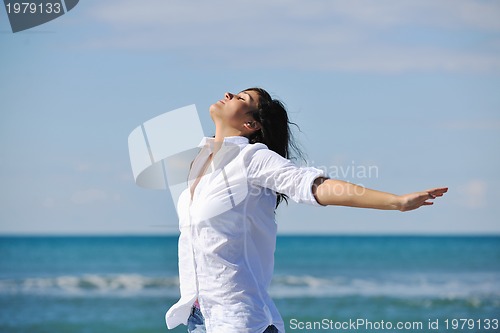Image of happy young woman on beach