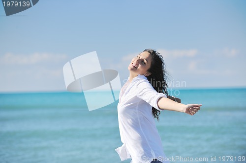 Image of happy young woman on beach