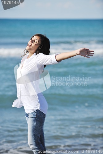 Image of happy young woman on beach