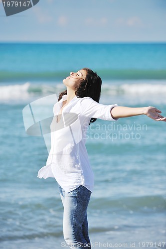 Image of happy young woman on beach