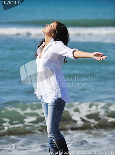 Image of happy young woman on beach