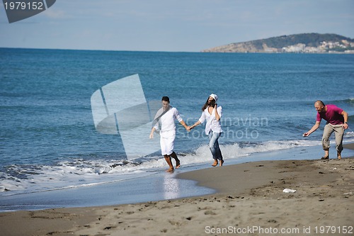 Image of happy young couple have fun at beautiful beach
