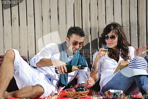 Image of young couple enjoying  picnic on the beach