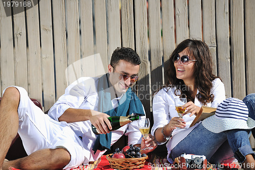 Image of young couple enjoying  picnic on the beach