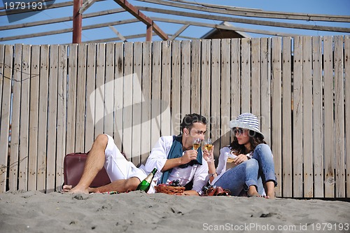 Image of young couple enjoying  picnic on the beach