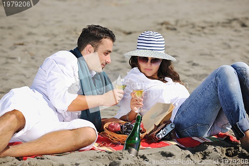 Image of young couple enjoying  picnic on the beach
