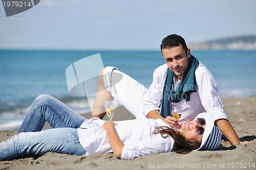 Image of young couple enjoying  picnic on the beach