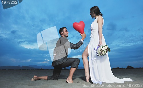 Image of romantic beach wedding at sunset