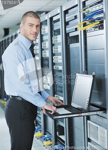 Image of young it engeneer in datacenter server room