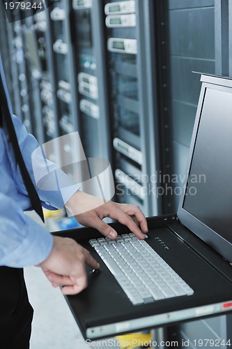 Image of young it engeneer in datacenter server room