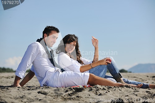 Image of young couple enjoying  picnic on the beach