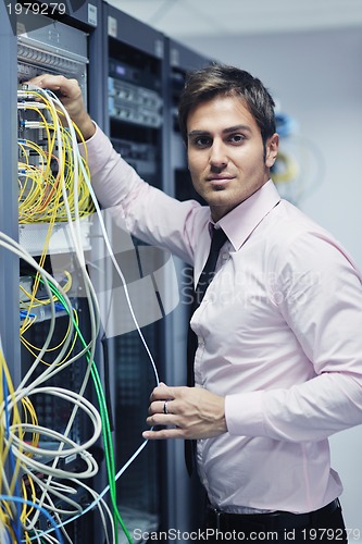 Image of young it engeneer in datacenter server room