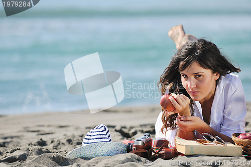 Image of happy young woman on beach