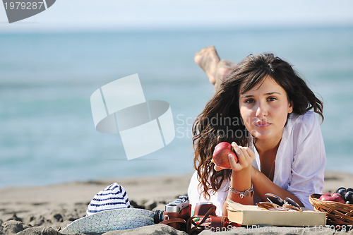 Image of happy young woman on beach